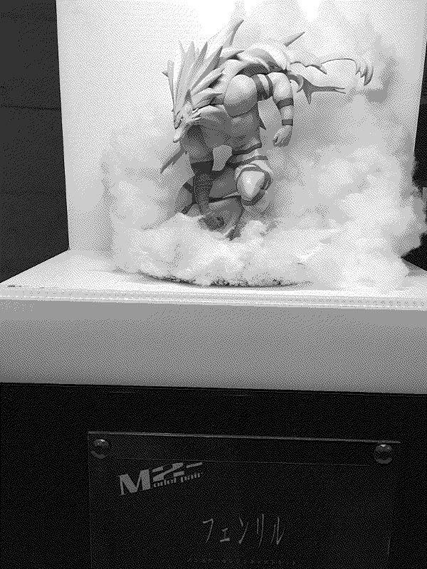 Photo of Model2-'s Fenrir zoomed out to capture the placard with the artist's info and the smoke around the figure.