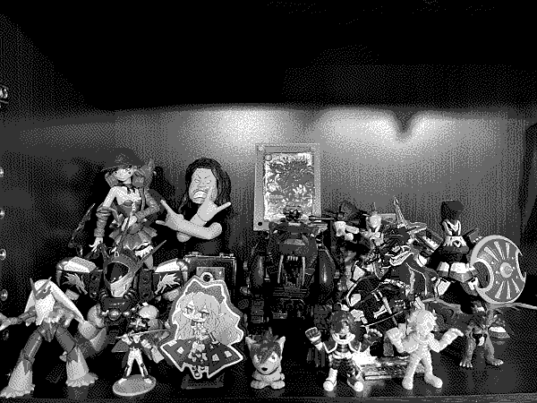 A massive shelf of toys and acrylic charms based on Hideaki Fujii's past works, including DANDAN's Elegy from 2014.