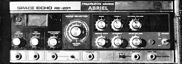 A Roland Space Echo tape delay effect machine, with a sticker applied on the top of the front panel reading; THE CREATIVE ANSWER ABRIEL.