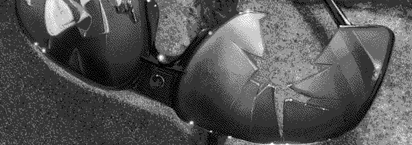 A pair of shattered sunglasses on the pavement, the reflection of a gunman walking away visible in one lens.