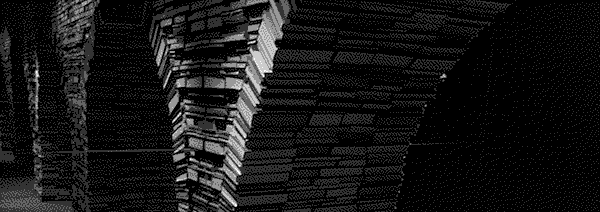 An archway made of books extends into the darkness.